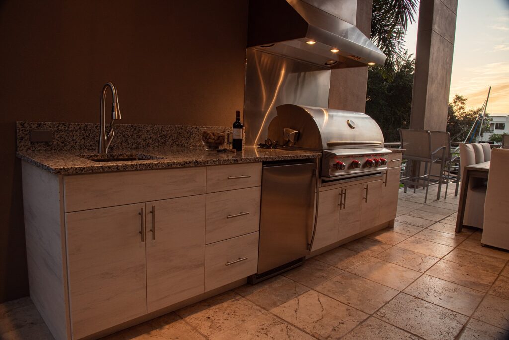 Outdoor kitchen installation with built-in grill and cabinetry
