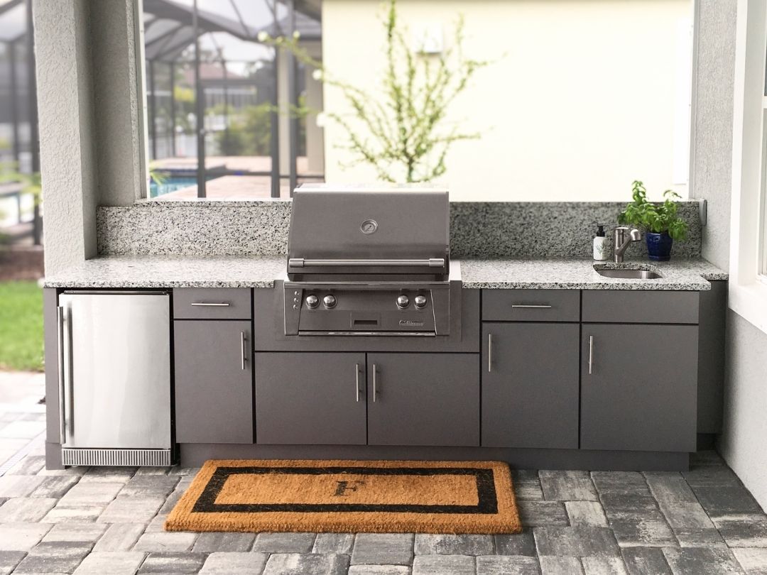 Custom outdoor kitchen with built-in appliances designed for convenient outdoor cooking and entertaining